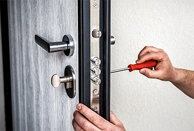 A closeup of one of our locksmith’s hands as they change the lock on a Hobart client’s front door.