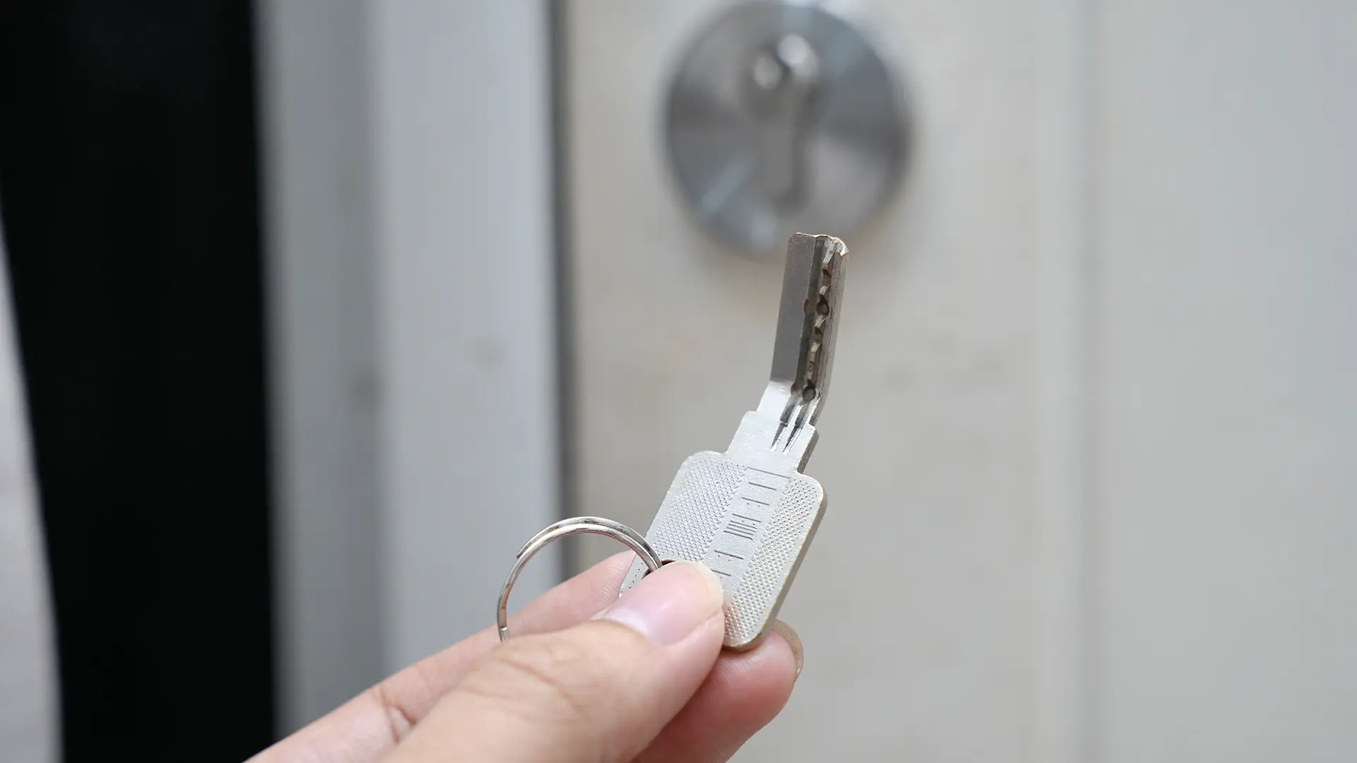 A close-up of a client’s hand holding a bent house key. This happens all the time, and our broken key extraction locksmiths help Hobart clients with issues like this all the time.