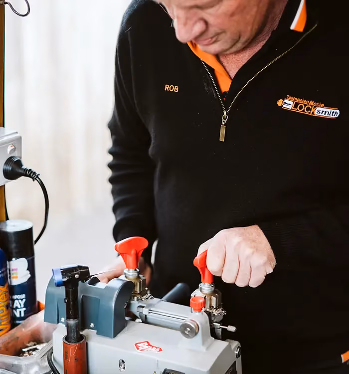 Man from the Tasmanian Mobile Locksmith team works on a new locksmithing job.