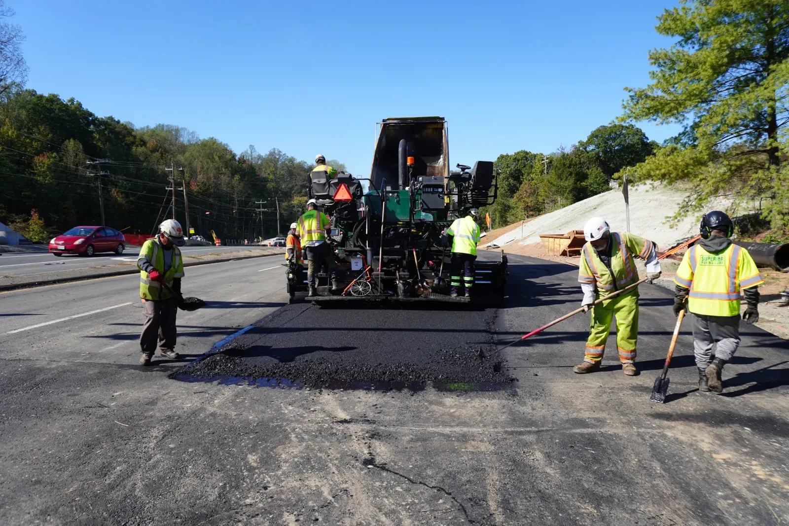 Superior Paving crew laying asphalt behind a paver on a Virginia road job