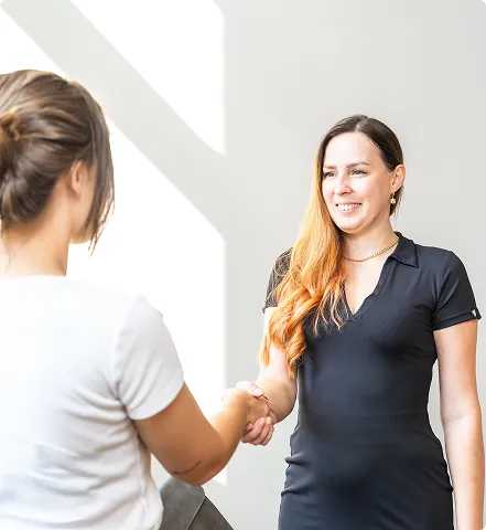 Tax Expert greeting a client with a handshake