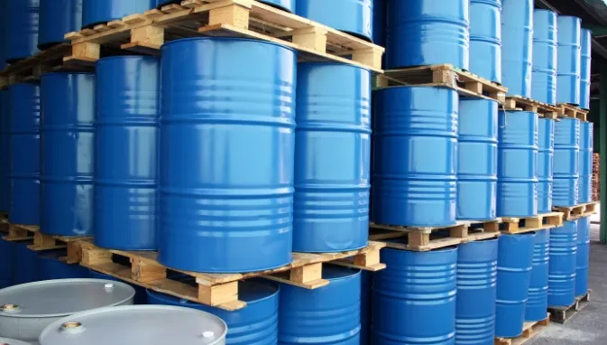 Pallets stacked with metal drums