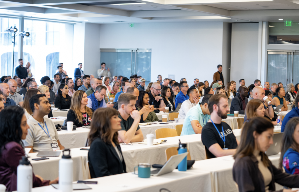 Large audience of professionals attentively listening at CT scaling workshop