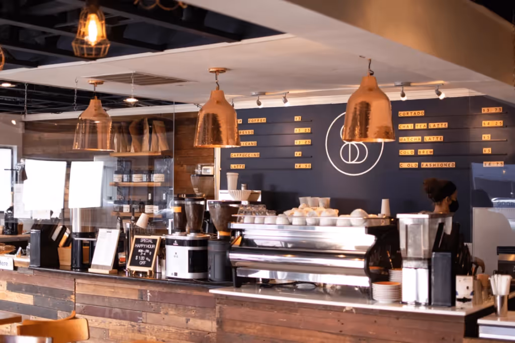 A cozy coffee shop counter showcasing a variety of beverages and pastries, with a rustic and warm ambiance.
