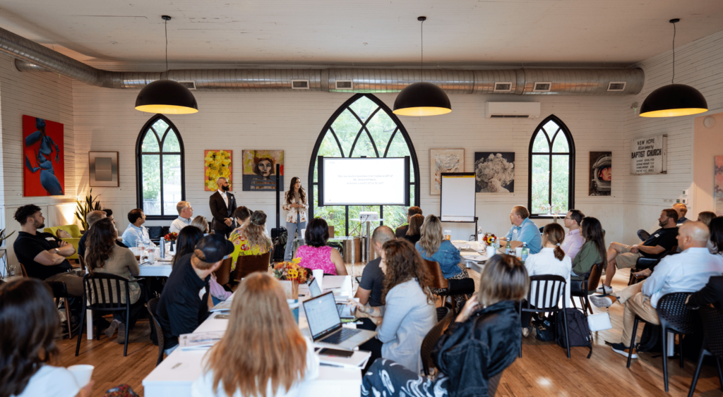 Scaling workshop setting with Codie Sanchez addressing an audience of entrepreneurs.