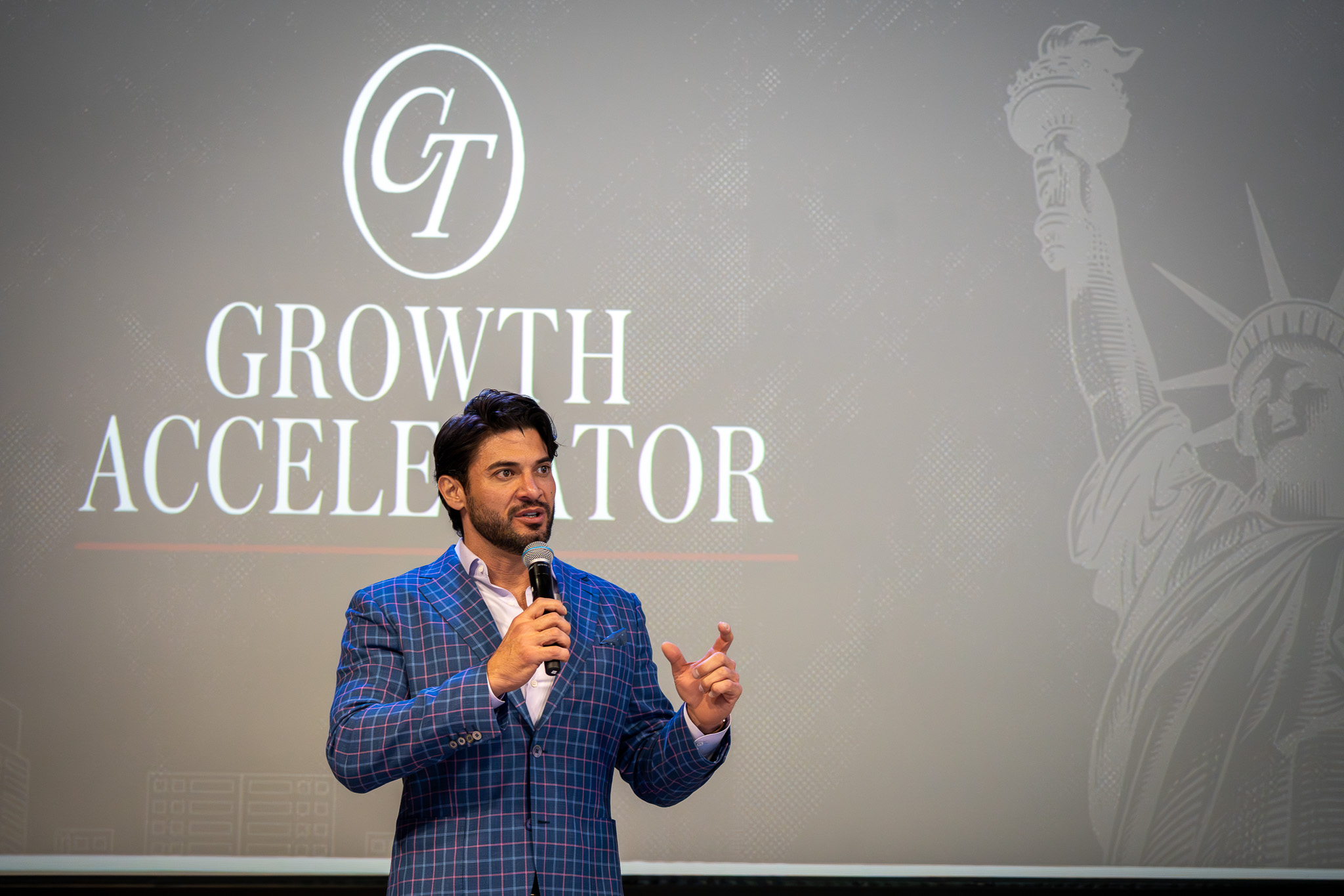 Alex Hooper speaking on stage at the Growth Accelerator Workshop