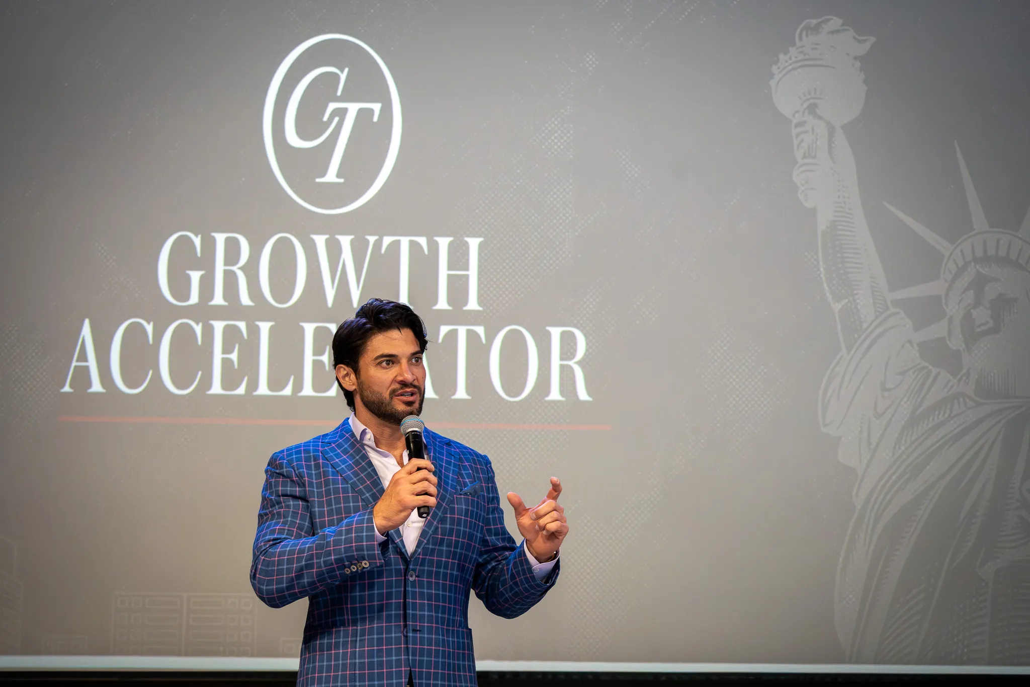 Alex Hooper speaking on stage at the Growth Accelerator Workshop