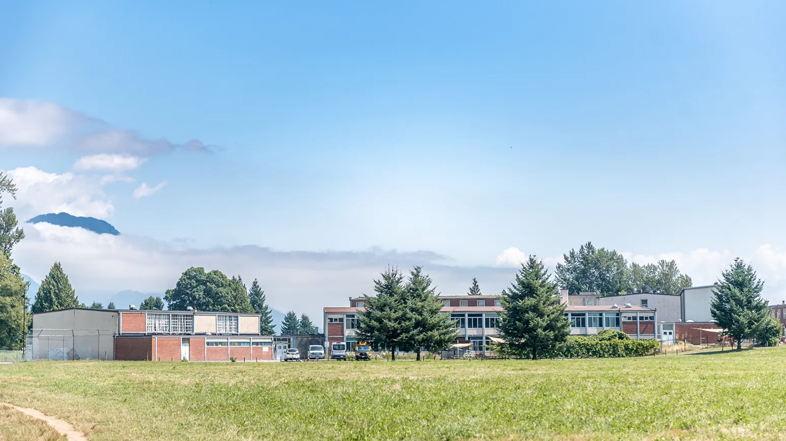 A grassy field with a building in the background.