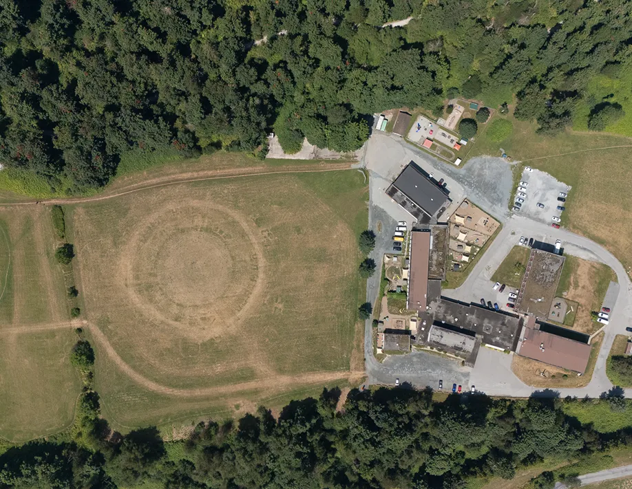 An aerial view of a school in the middle of a field.