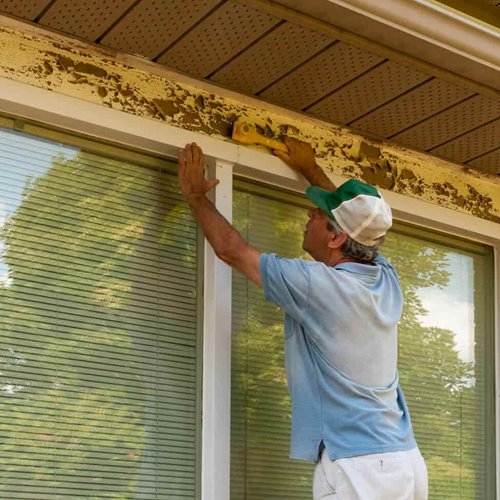 Scraping peeling paint on exterior
