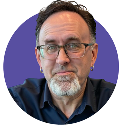 Middle-aged man with glasses, short dark hair, and a gray goatee wearing a dark blue shirt against a purple circular background.