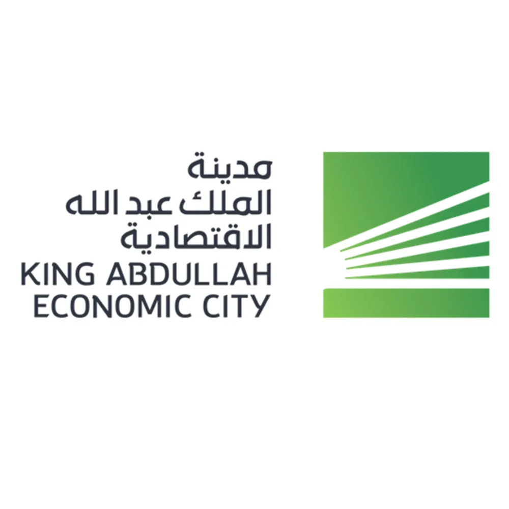 King Abdullah Economic City logo with Arabic and English text and a green stylized design.