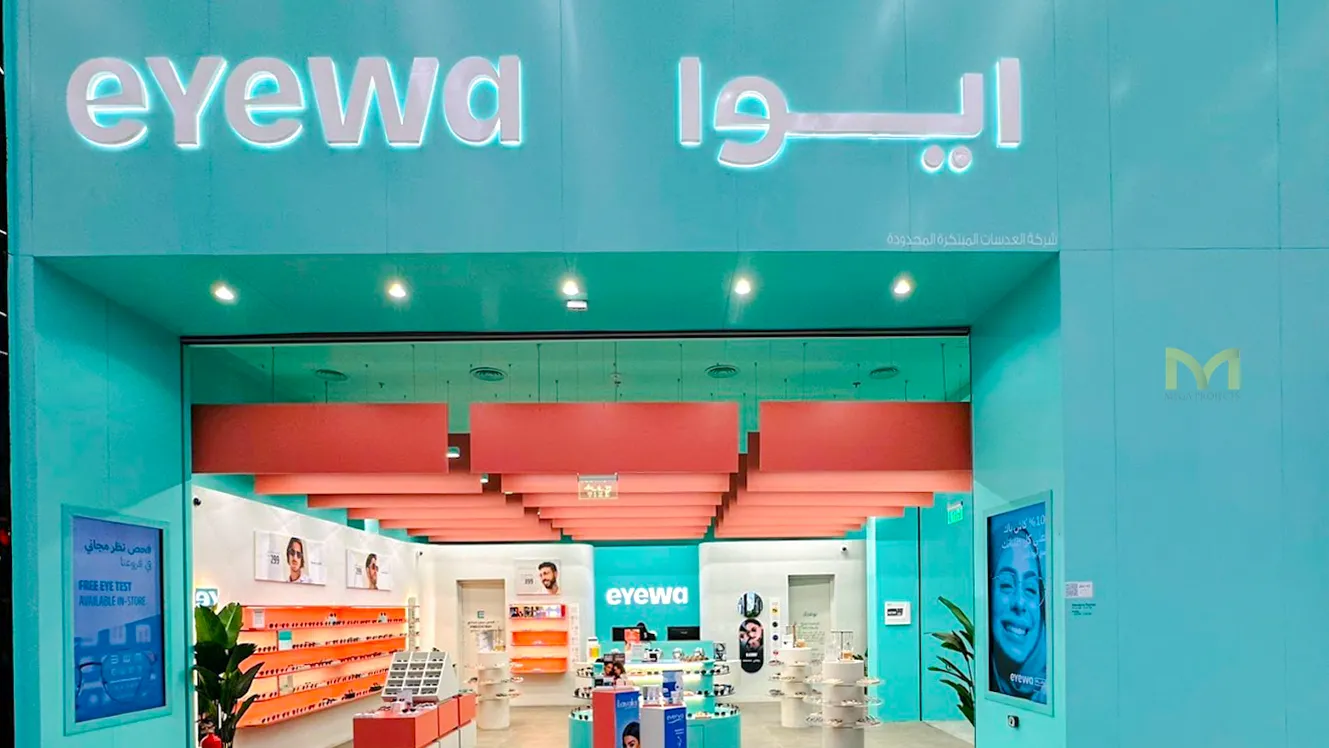 Eyewa store entrance with teal walls, orange ceiling panels, and sunglasses displays inside.