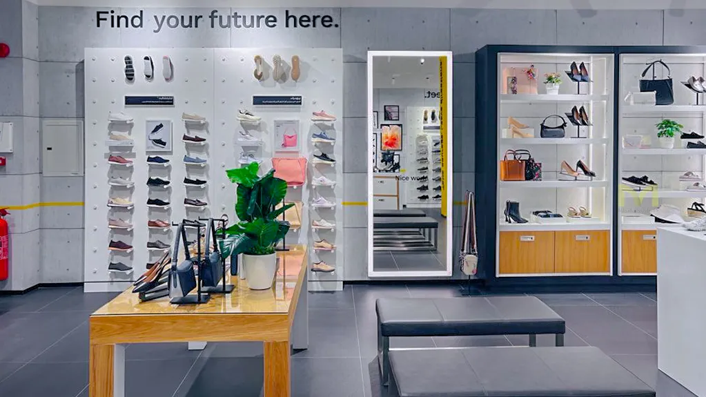 Modern retail store interior displaying shoes, handbags, and accessories with a 'Find your future here' sign.