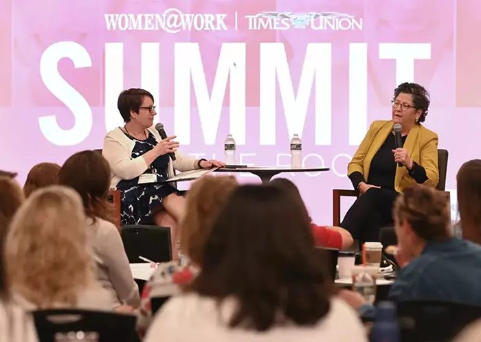 Hearst Chief Legal Officer Eve Burton speaking onstage opposite moderator. 