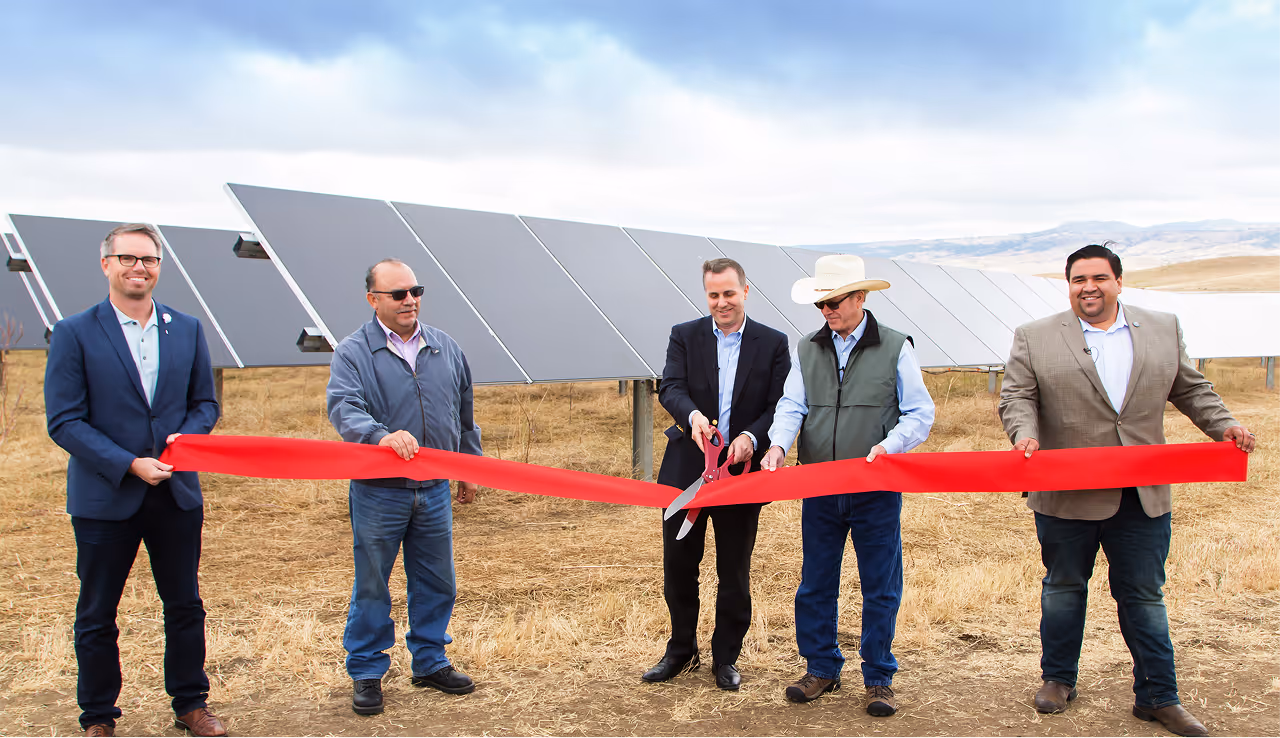 Colleagues cut ribbon above Hearst Ranch logo. 