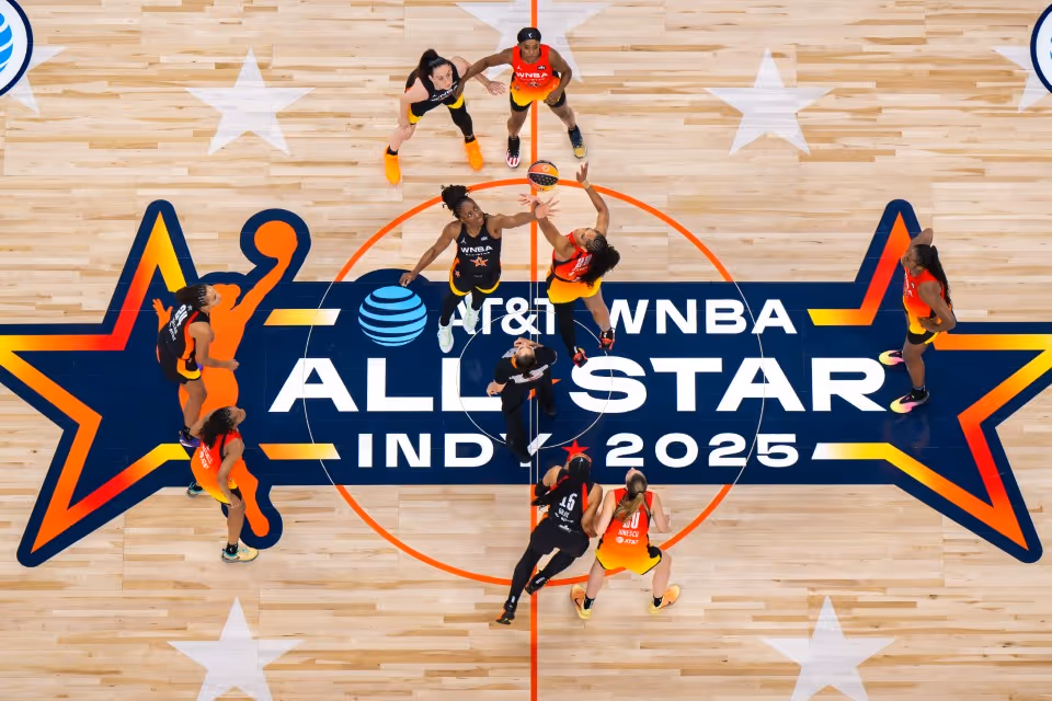 WNBA players on the court at tip-off.