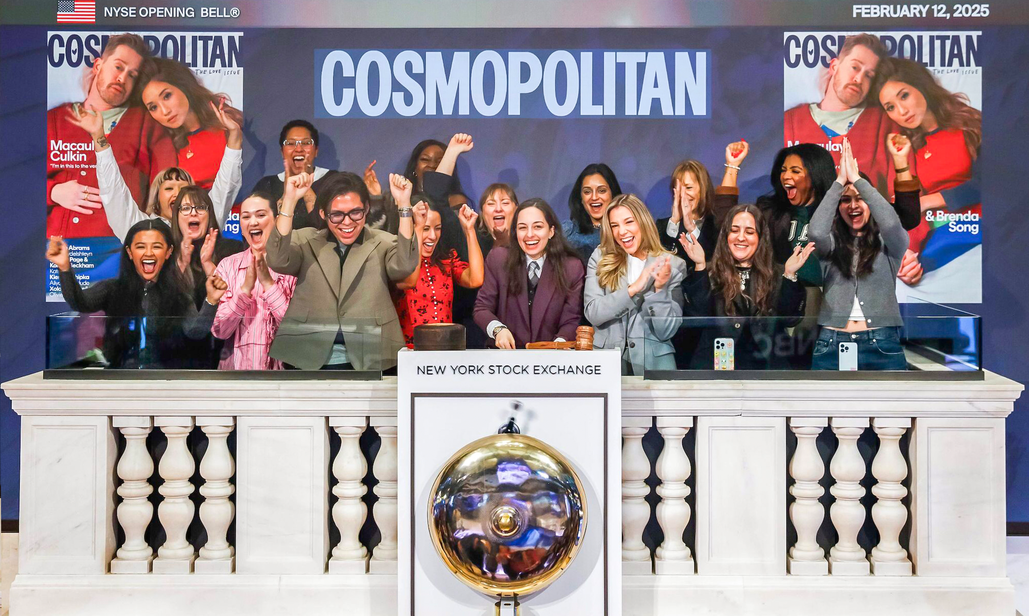 Willa Bennett rings New York Stock Exchange bell surrounded by Cosmopolitan colleagues. 