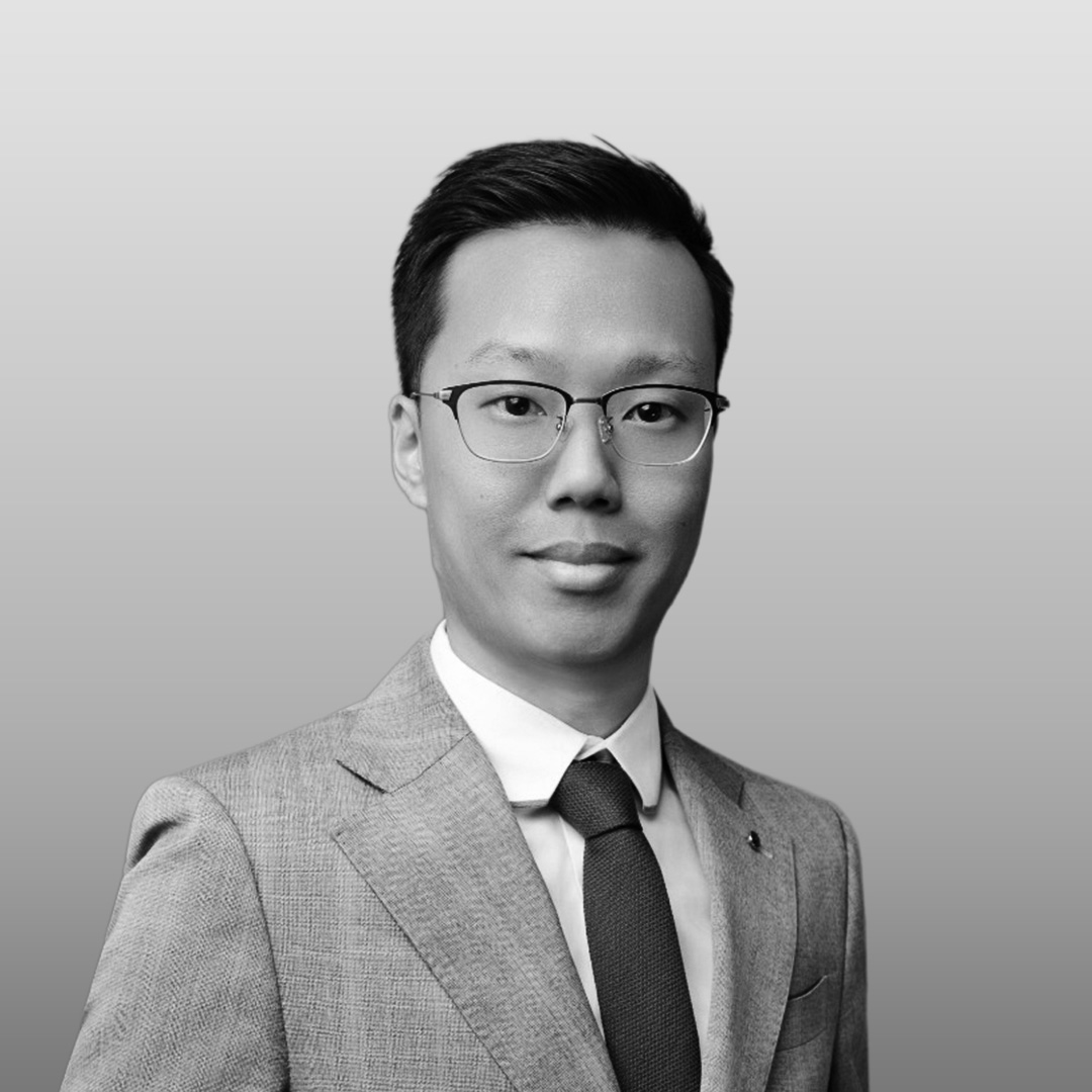 Portrait of Nigel Ko, Xtra Sensing Co-Founder. Wearing a dark suit jacket and white shirt against a plain background.