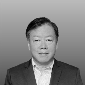 Portrait of Nigel Ko, Xtra Sensing Co-Founder. Wearing a dark suit jacket and white shirt against a plain background.
