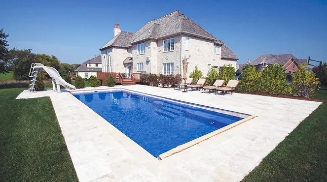 A house with a pool and a slide in the yard.