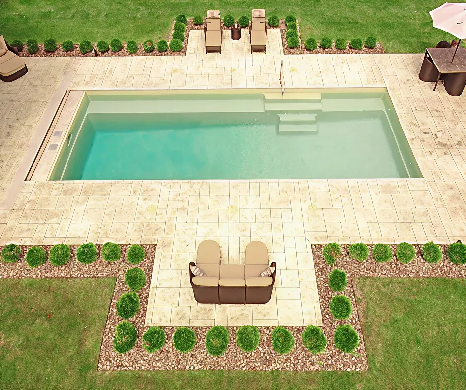 An aerial view of a backyard with a pool and patio furniture.
