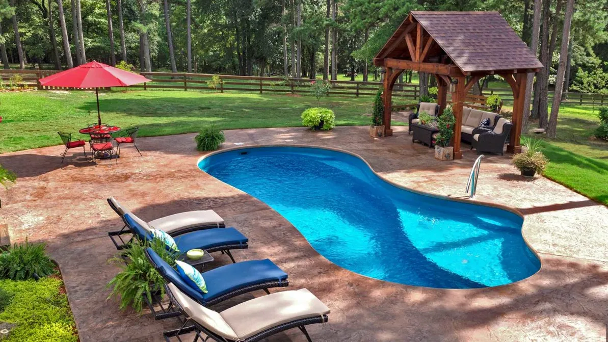 A backyard with a pool and a gazebo.