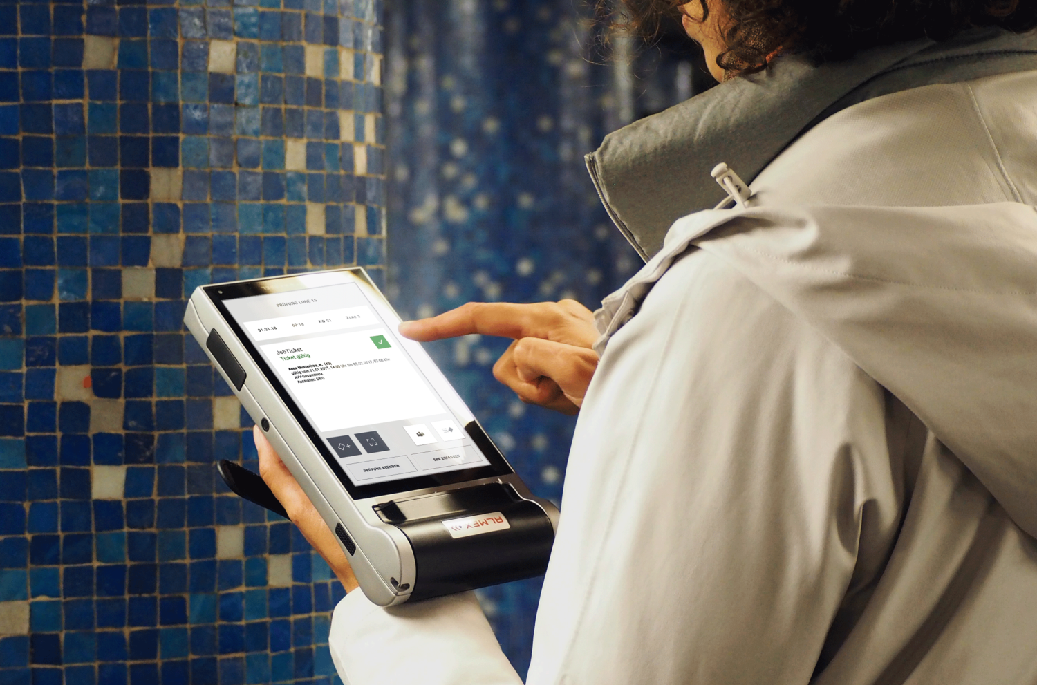 Person hält in der linken Hand ein Handheld und bedient es mit der rechten Hand.