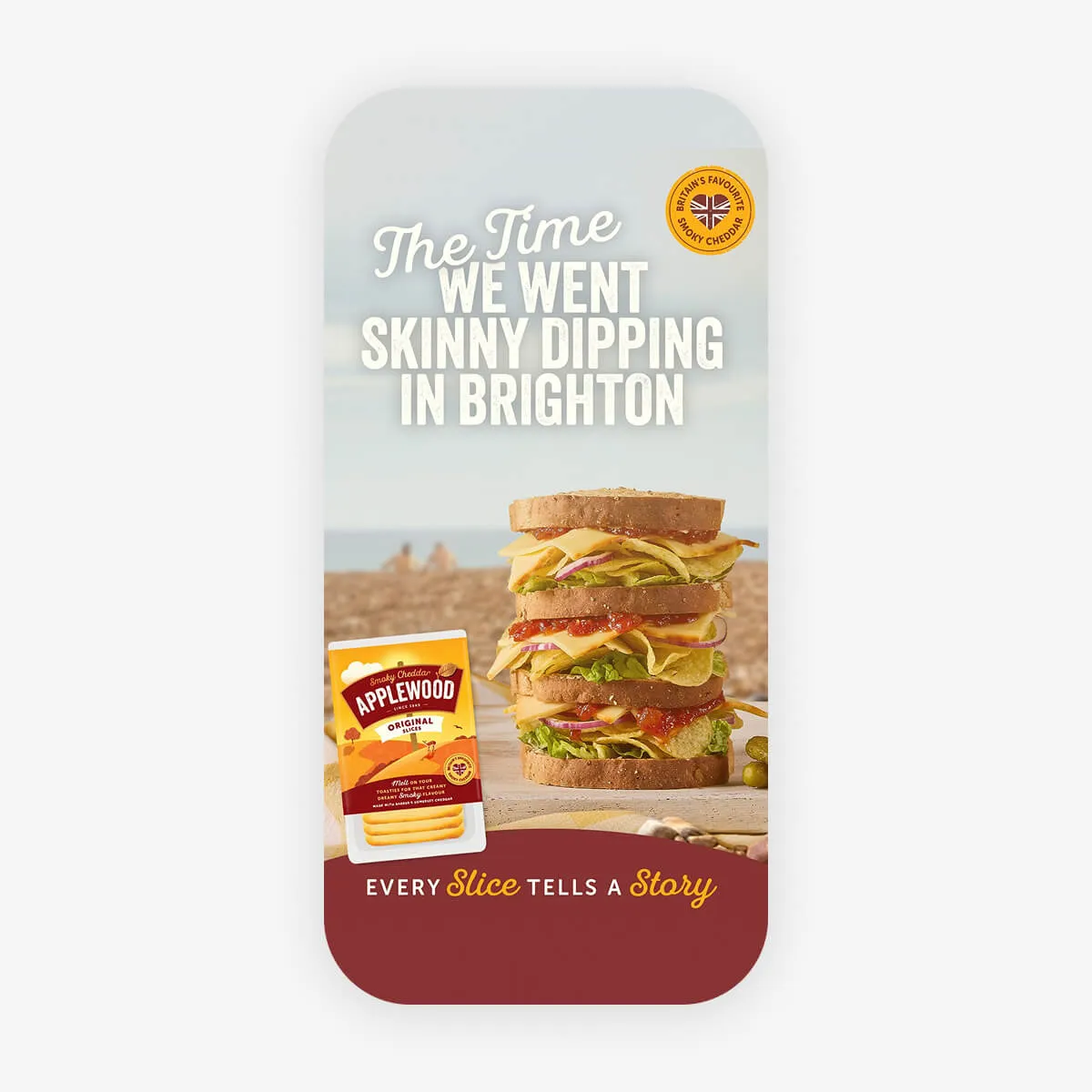 Stacked sandwich with lettuce, red onion, cheese, and sauce next to a pack of Applewood smoky cheddar cheese slices, with the text 'The time we went skinny dipping in Brighton' and 'Every slice tells a story'.