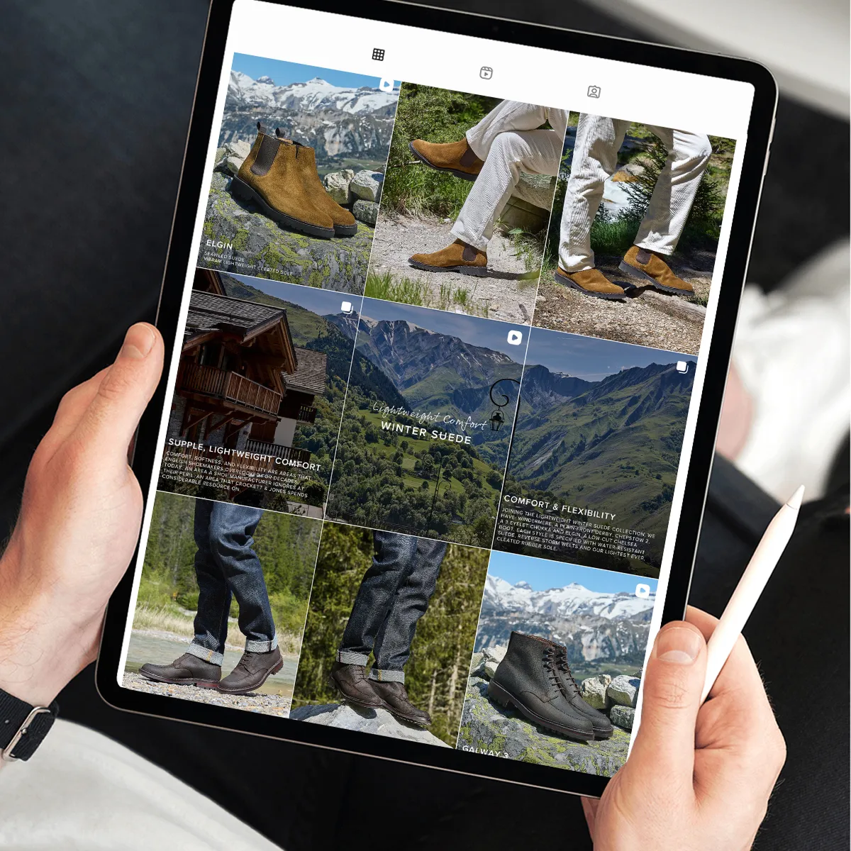 Person holding a tablet displaying Crockett & Jones brand's Instagram grid featuring brown and black suede boots with scenic mountain backgrounds.