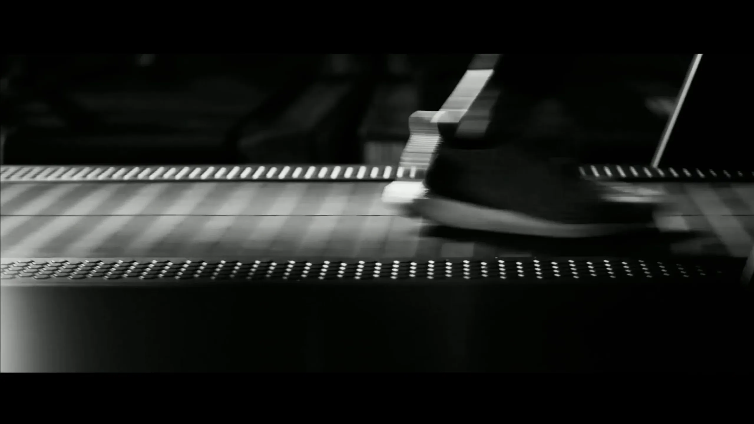 Close up of a runner on a treadmill shot in black and white