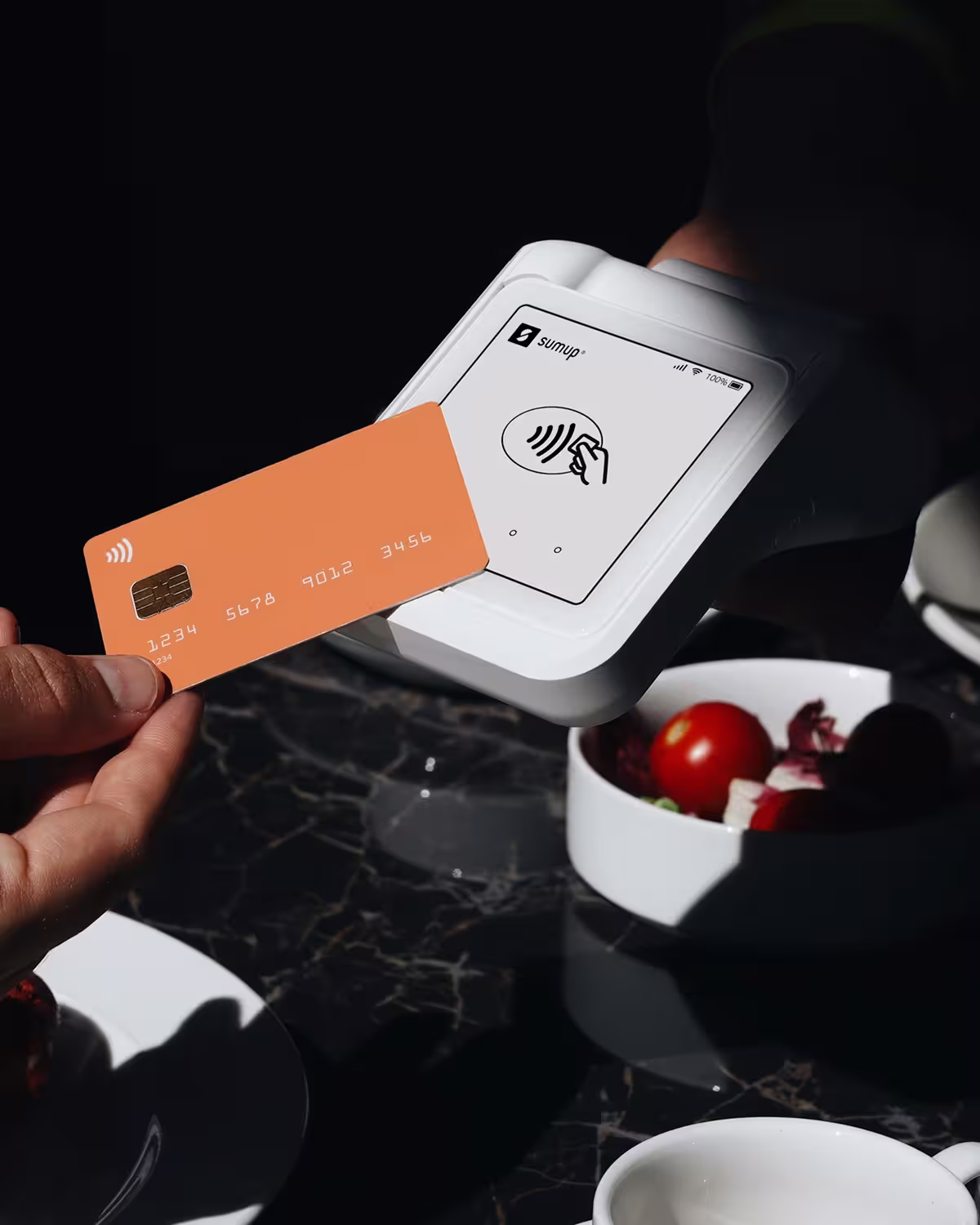 Someone using a card to pay at a card terminal