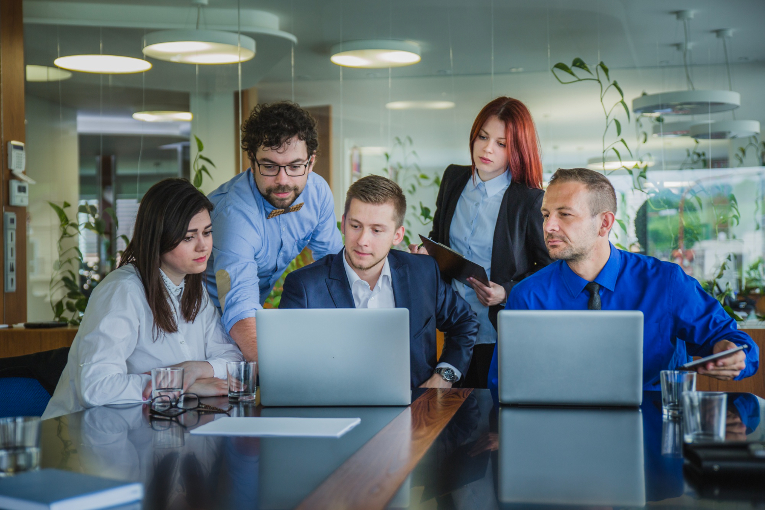 a group of people looking at a laptop