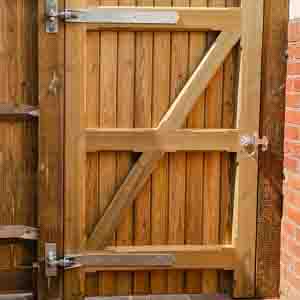 Framed T&G side gate with galvanised hinges, latch, and cross brace.