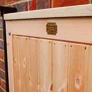 Closeboard pedestrian gate with top capping and latch, fitted beside brick pier.