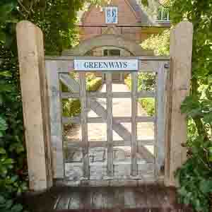 Decorative timber pedestrian gate with diamond lattice top and framed design.