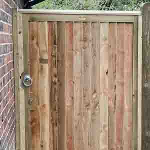 Framed closeboard pedestrian gate with natural timber finish and weather capping.