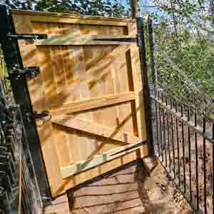 Heavy-duty framed pedestrian gate with cross brace and black ironmongery.