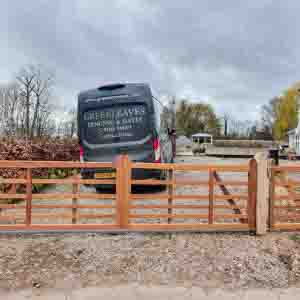 Contemporary horizontal timber entrance gates with galvanised frame and hinges.