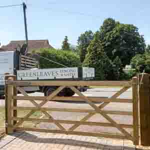 Driveway entrance with five-bar timber gates and field-style design for easy access.