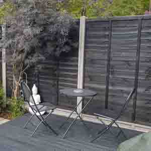 Modern black composite fence panels providing a sleek, contemporary garden boundary.