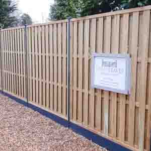 Closeboard panel fencing with gravel boards and capped posts, offering a strong garden boundary.