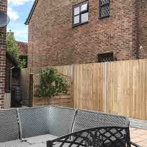 Simple timber fencing with capping rail, designed for a modern suburban garden.
