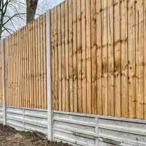 Treated timber panel fencing with reinforced posts for a neat and secure garden boundary.