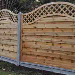 Decorative curved-top panel fencing with trellis design, offering both privacy and elegance.