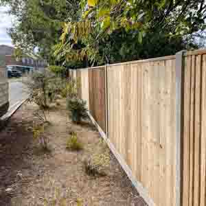 Closeboard fence with concrete posts and gravel boards securing a narrow side passage.