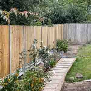 Timber fence with concrete posts and gravel boards enclosing a neat garden border.