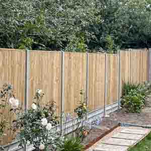 Closeboard fencing with concrete posts and gravel boards finished with a capping rail.
