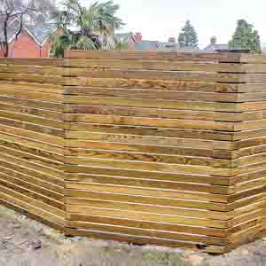 Weathered horizontal slatted fence giving a rustic contemporary look to the garden.