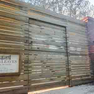 Timber slatted screen set behind a planter to create a private seating area.